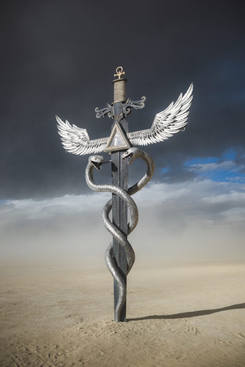 Jai Hackl’s monumental winged sword sculpture with twin serpents on the desert playa